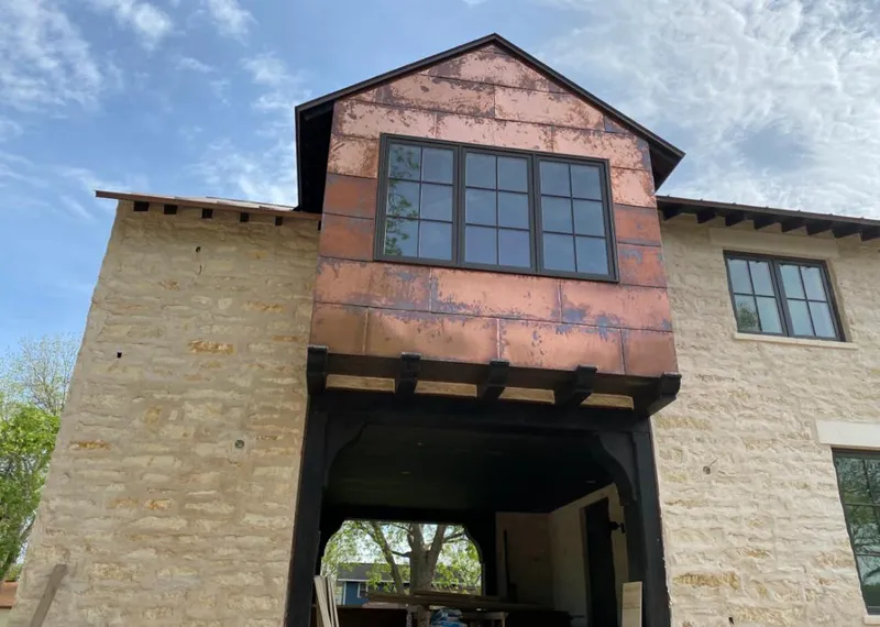 Copper metal panel facade on a stone building for Roof Repair in West Orange